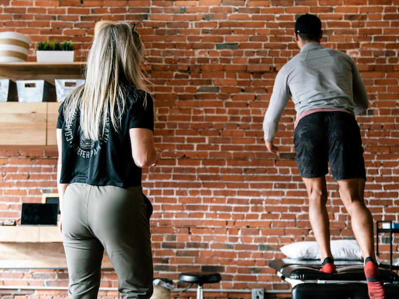 physical therapist working with patient to strengthen calf muscles