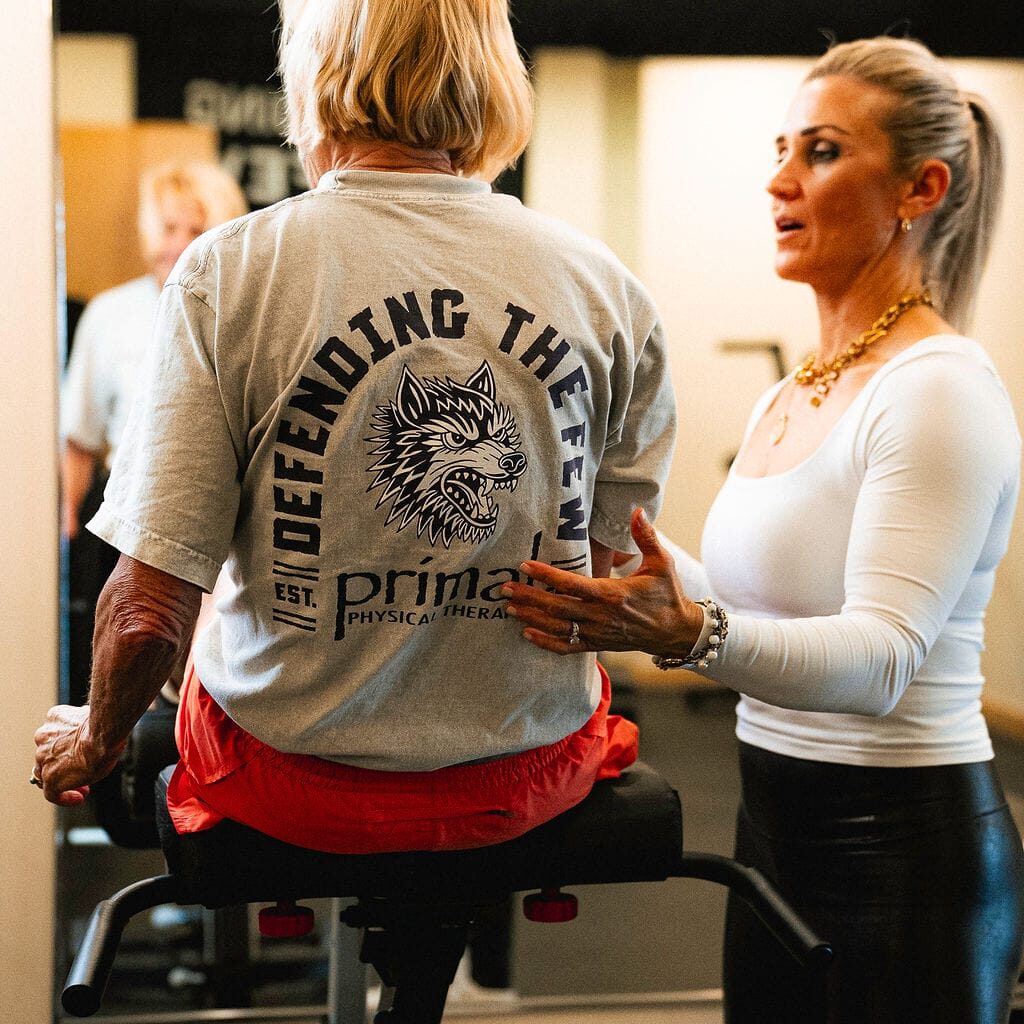 Physical therapist explaining the anatomy of the spine and stabilizing muscles to a patient.