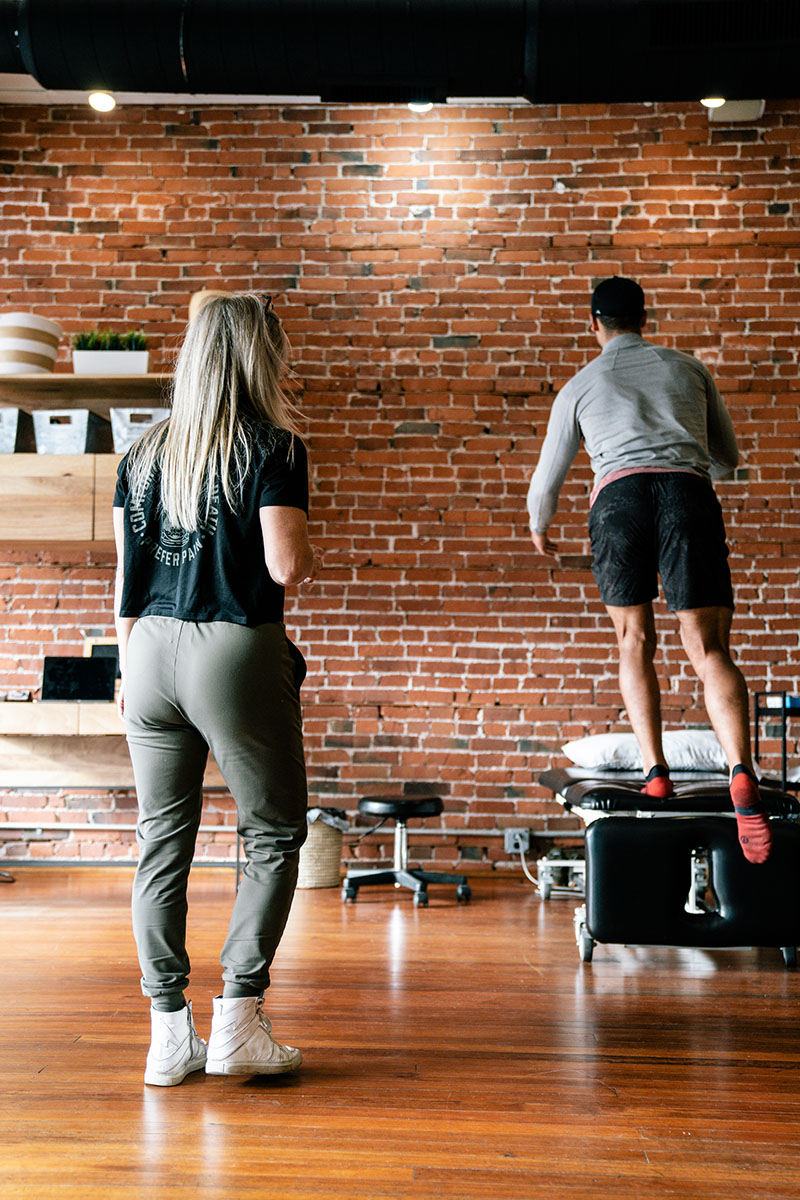 Patient performing substitution exercises using visual cues and proprioception to maintain balance.