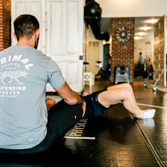 Dr. Eric Abramowitz, TPI Medical Level 2 Certified Physical Therapist, evaluating a patient's movement.